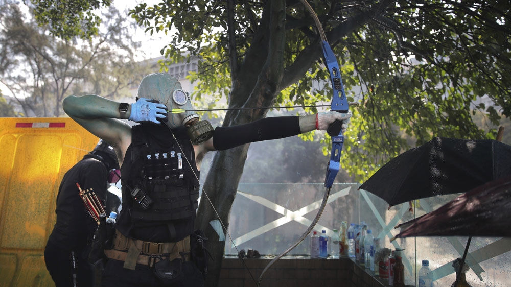 Hong Kong police break through barricades of a besieged university campus to arrest protesters